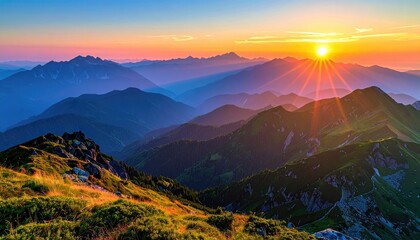 Scenic Mountain Range at Sunrise with Golden Light and Layered Ridges Under a Vibrant Blue Sky and Sunlight Beams