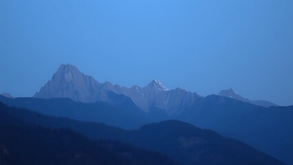 A mountain landscape during blue hour, with a soft twilight glow enhancing the natural scenery.