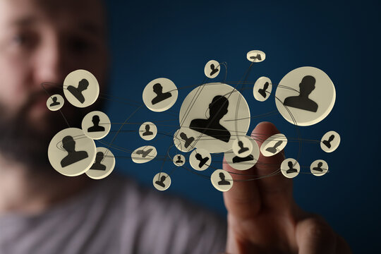 Finger interacting with a network of digital people, symbolizing collaboration and innovative human connection in the modern workplace.