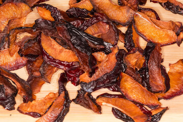 Dried plums slices close-up on a wooden surface