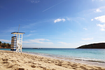 Fototapeta premium A Stunning Scenic Beach Showcasing a Lifeguard Tower Under a Bright Sunny Sky