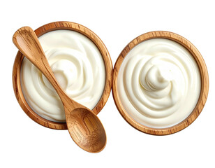 Creamy white dairy in wooden bowls with a wooden spoon, isolated on black