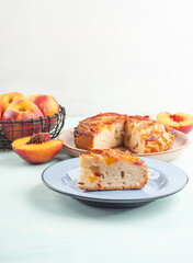Piece of nectarine peach cake on turquoise table