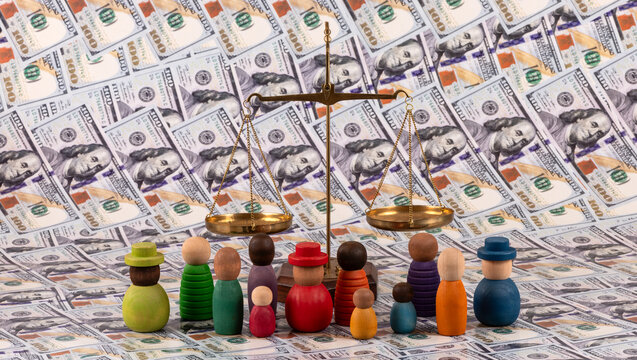 A group of symbolic wooden people  and golden scales against a background of $100 bills.