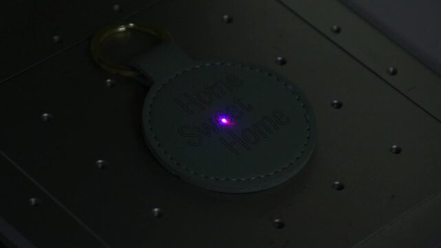 Close-up video of laser engraving on leather keychains using a blue laser. The footage shows the precision process of creating personalized designs on colorful leather accessories. Perfect for illustr