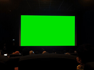 a large green screen for mockup in a cinema or theater setting
