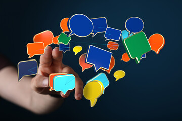 Concept of communication represented by a hand interacting with floating speech bubbles for...
