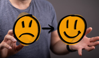 Abstract concept of emotional transition from sadness to happiness, represented by changing emoji faces, symbolizing mental health, therapy, and