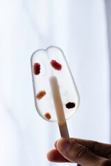 Hand holding healthy dessert mulberry fruit jelly agar-agar