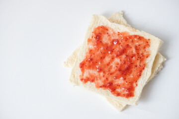 Close-up of white bread with raspberry jam