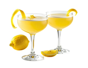 Two elegant cocktails with lemon twists, beside a lemon. Close-up shot