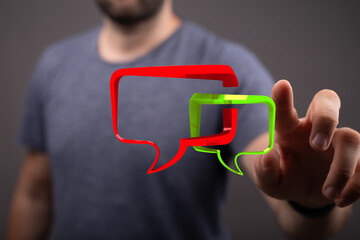 Man points to interactive speech bubbles, visualizing connection and dialogue. Communication and engagement concept.