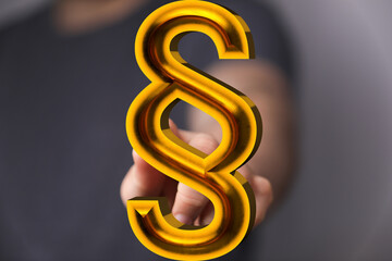 Obraz premium Abstract image of a golden paragraph symbol. Perfect for legal, justice, and law concepts.