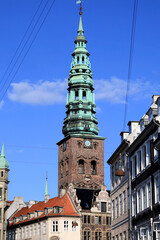 Vertical photo with a street view and the Nikolaj Church-Museum building in the historic center of Copenhagen, Denmark