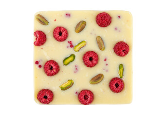 Delicious white chocolate bar with raspberries and pistachios isolated, gourmet dessert with nuts and berries