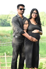 Happy couple celebrating their pregnancy outdoor