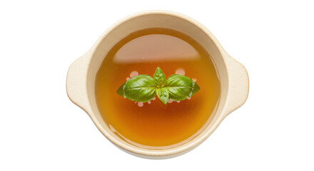 Chicken broth in bowl isolated, clear soup with basil leaf garnish for healthy eating and wellness, on transparent background
