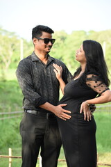 Happy couple celebrating their pregnancy outdoor