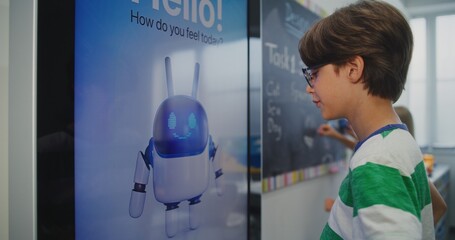 Close Up of Schoolchild in Good Mood Interacting With AI Based Mood Tracking Tool in Modern Classroom. Concept of Integrating Educational Technologies and Supporting Mental Health. Static Shot.