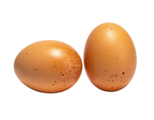 Two speckled, brown eggs stand isolated against a stark black background