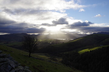 sun breaking through clouds in lake district