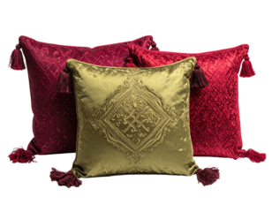 Three textured velvet pillows with tassels and embroidered central pillow