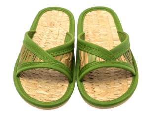 Two straw and green sandals sit side-by-side, ready for summer wear