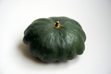Close-up of green custard marrow pumpkin indoors against white background. Photo taken September 30th, Zurich Schwamendingen, Switzerland.