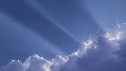 Soft blue sky with silver lined cumulus clouds and dramatic crepuscular rays streaming diagonally through atmospheric haze at sunrise serene luminous heavenly light scene