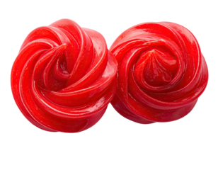 Two glossy, swirled, red candies resembling roses against a stark black backdrop