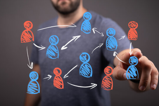 Man interacting with a virtual network of diverse people icons connected by arrows, illustrating social connections, business communication, and - Powered by Adobe