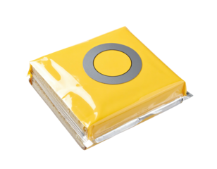 Bright yellow square food item, sealed in clear plastic wrap, with a gray circle