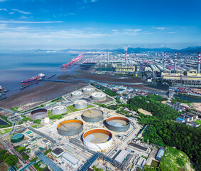 Aerial view of a large oil refinery and industrial port with power plants and storage tanks on the...