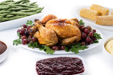 Thanksgiving dinner on rustic wooden table with turkey,mashed potatoes,ears of corn and green bean casserole