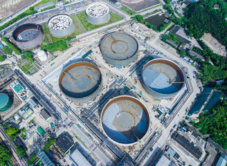 Aerial view of petrochemical storage tank facility in a large industrial complex.