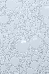 The texture of the foam of shower gel or soap suds. Macrophotography