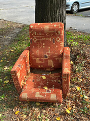 Old ruined armchair under a tree outdoor