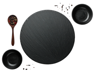 Culinary composition round slate board, bowls, wooden spoon with peppercorns