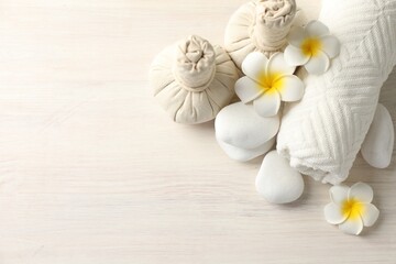Beautiful spa composition with herbal bags on white wooden table, flat lay. Space for text
