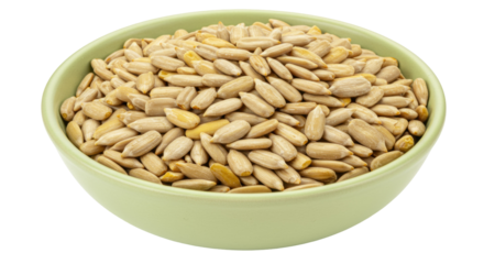 Pile of hulled sunflower seeds in a green bowl isolated, healthy snack food rich in vitamin E and linoleic acid