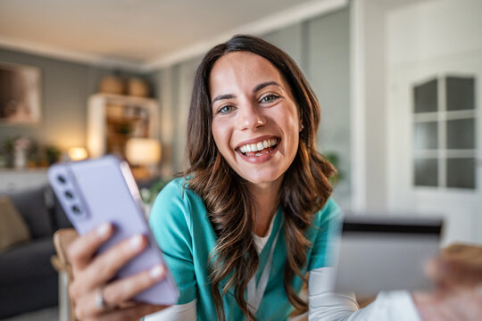 Happy young woman smiling on smartphone video call - Powered by Adobe