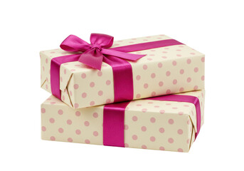 Isolated stack of two gifts wrapped in dotted paper with pink satin ribbons and a bow tied on top
