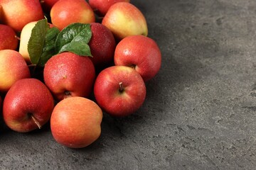 Fresh ripe apples on grey table, closeup. Space for text