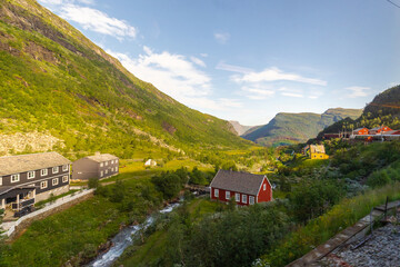 Amazing landscape of the Norwegian country during a perfect summer holiday with wonderful green fields, perfect cloudscape and breath-taking panoramic view as far as you can see with mountains and fjo