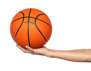 Hand holding a standard orange basketball against a stark black background