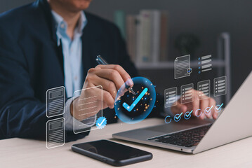 Businessman working on laptop with checklist approval, digital success planning, office technology, business analysis, productivity, organization, contract, document, goals, workflow, task management.