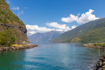 Fototapeta premium A beautiful Summer day in the UNESCO-listed Naeroyfjord in Norway, which is the most beautiful and wildest arm of the Sognefjord with at the end the picturesque village of Gudvangen, where you can sta