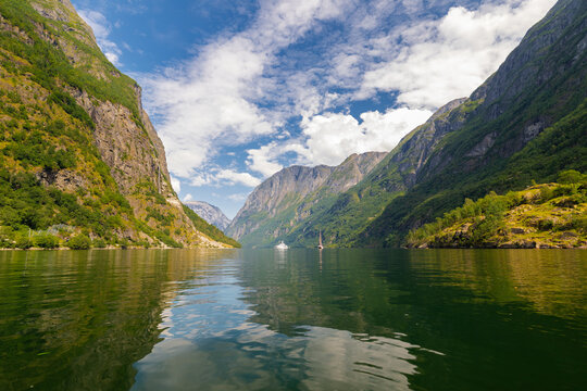 A beautiful Summer day in the UNESCO-listed Naeroyfjord in Norway, which is the most beautiful and wildest arm of the Sognefjord with at the end the picturesque village of Gudvangen, where you can sta