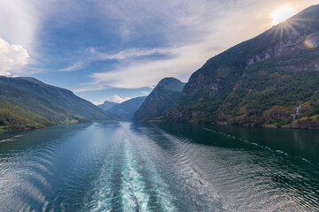 Amazing sunset views of the Sognefjord in Norway during a amazing Summer evening seen from the backside of a ship, when cruising through the unique natural landscape of Norway and its fjords, while th