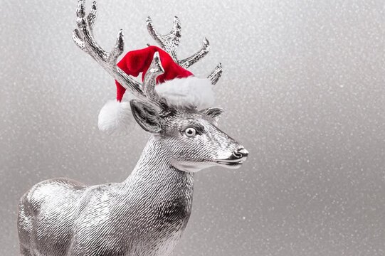 Silver deer in a Santa Claus hat
